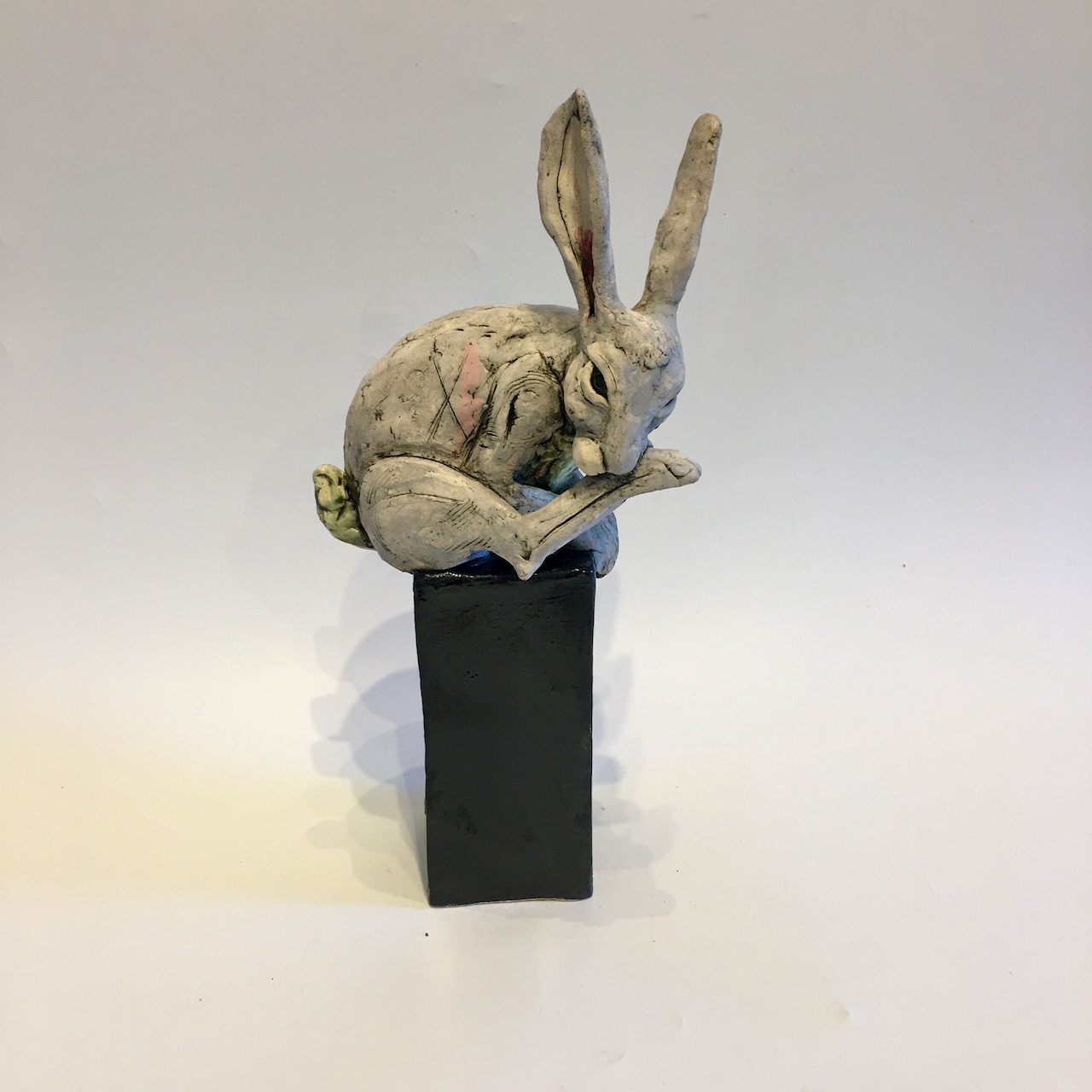 Grey hare on tall plinth