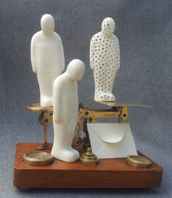 Three Figures on a Brass Postal Scale